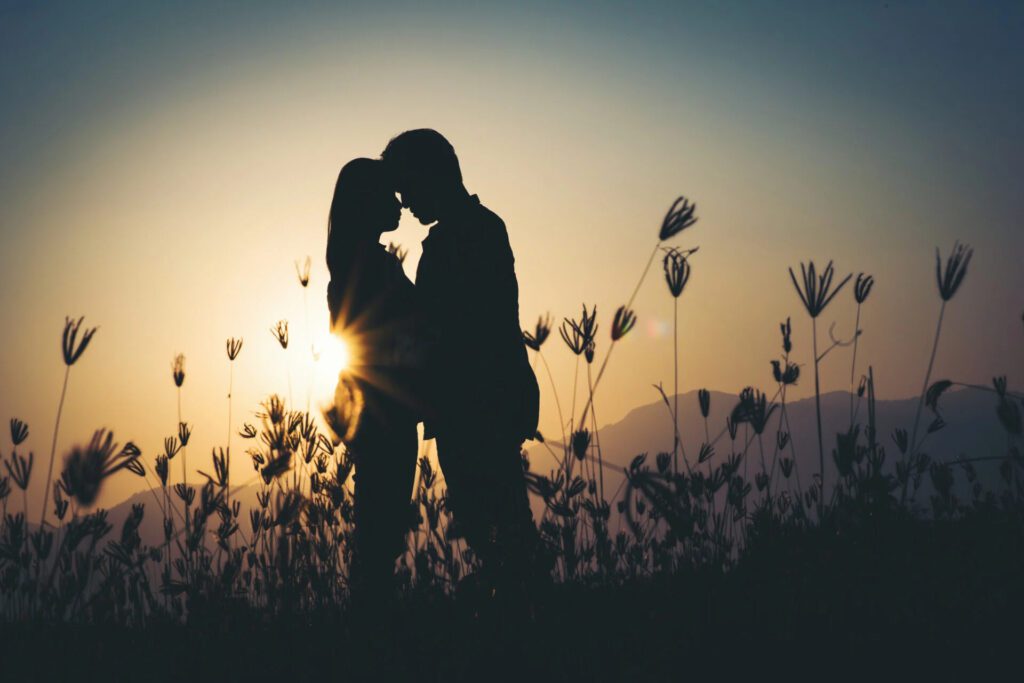 the silhouette of two people in love